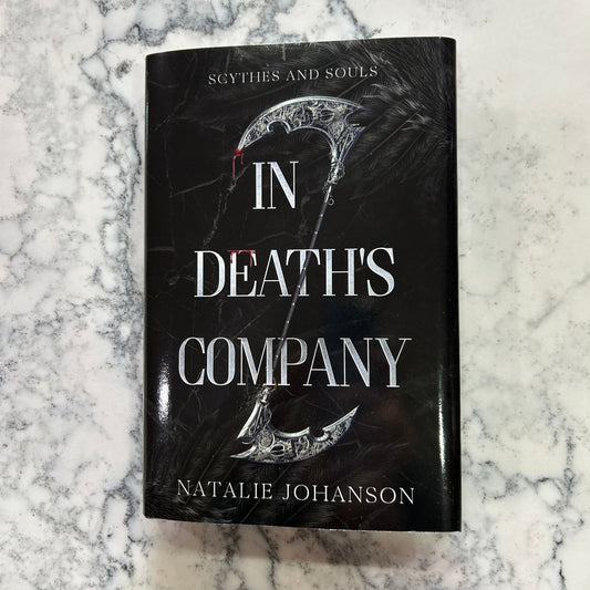 Book titled 'In Death's Company' by Natalie Johanson on a marble surface